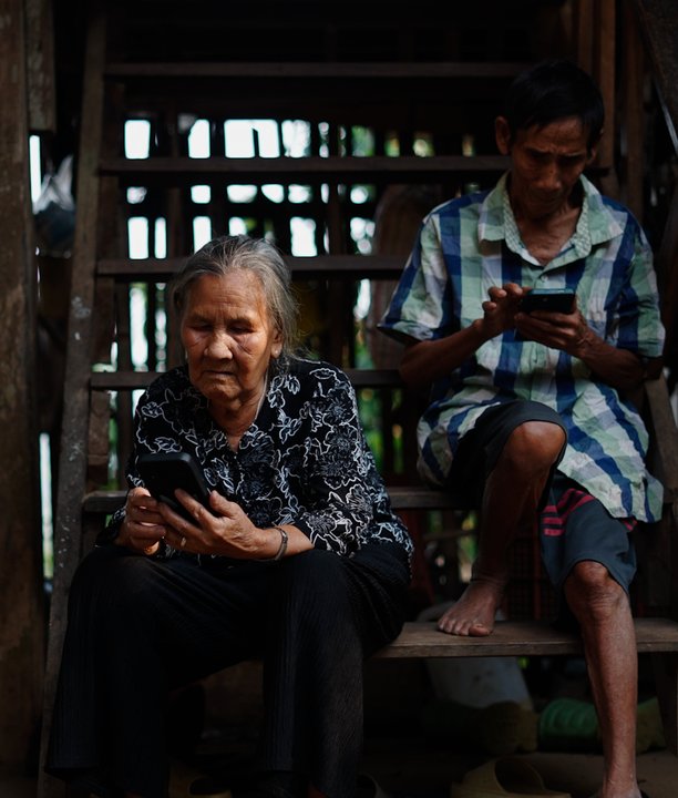 People in a rural setting using their phones.