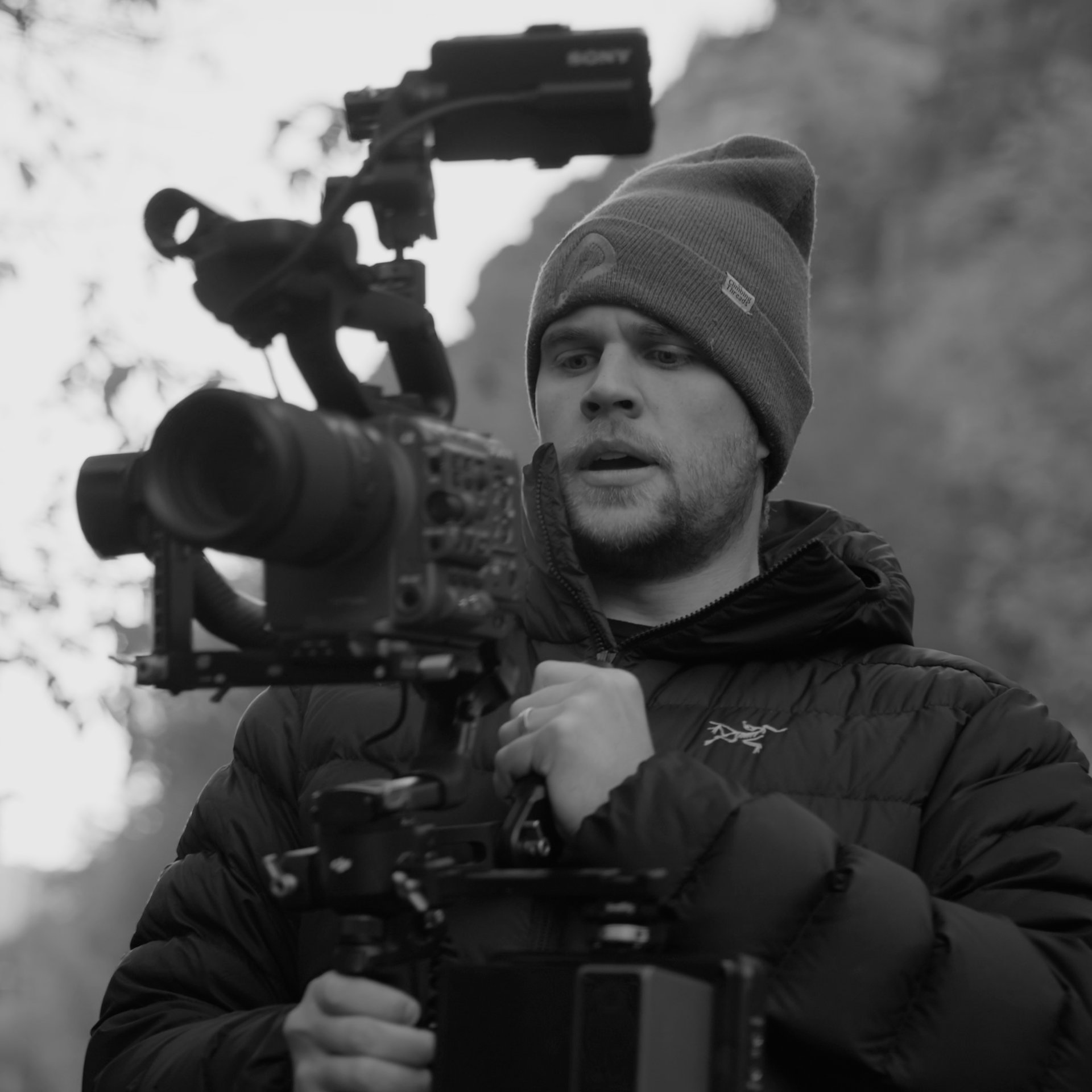 Tanner filming with a high-end camera.